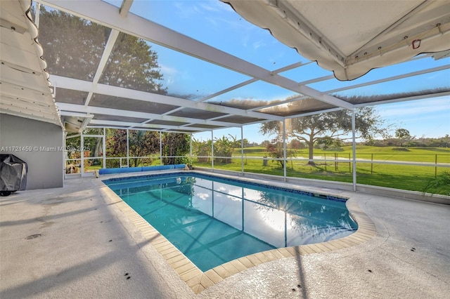 view of pool featuring glass enclosure and a patio