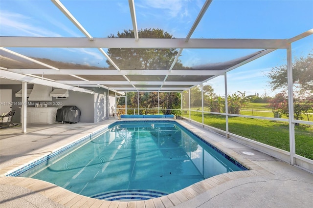 view of pool featuring area for grilling, a yard, glass enclosure, and a patio area