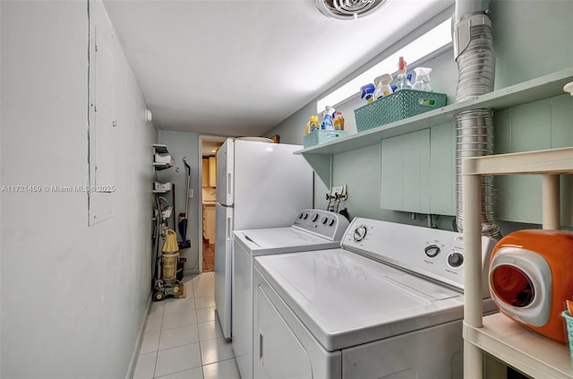 washroom featuring light tile patterned floors and washing machine and dryer