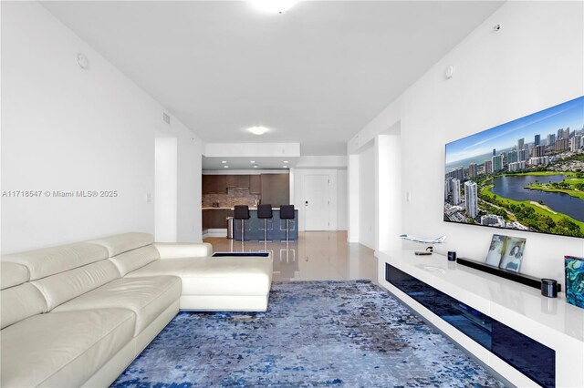 living room with tile patterned flooring and visible vents