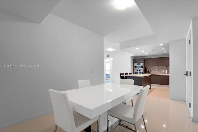 dining area featuring recessed lighting, baseboards, and light tile patterned floors