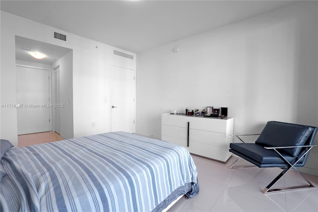 bedroom with visible vents and light tile patterned floors