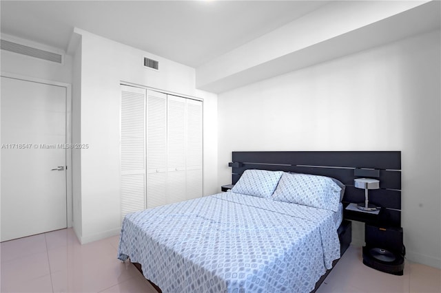 7751 NW 107th Ave Unit 509, Doral, FL 33178 - bedroom featuring baseboards, visible vents, a closet, and light tile patterned floors
