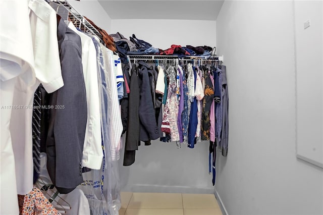 walk in closet with tile patterned flooring