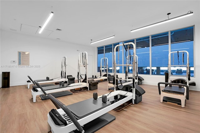 workout area featuring wood finished floors and visible vents