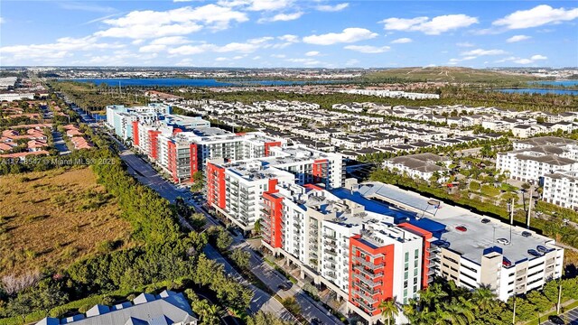 birds eye view of property featuring a water view and a city view