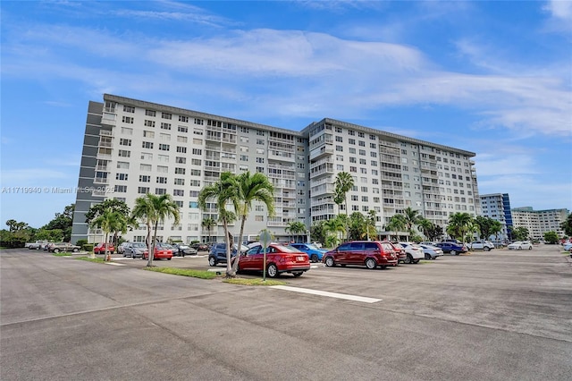 view of building exterior featuring a view of city and uncovered parking