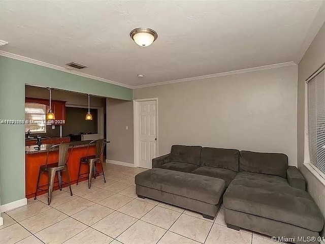 living room with crown molding and light tile patterned flooring