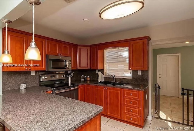 kitchen featuring sink, light tile patterned floors, hanging light fixtures, electric range, and tasteful backsplash