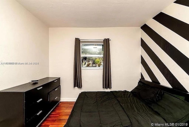 bedroom featuring dark hardwood / wood-style flooring