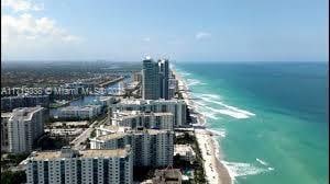 birds eye view of property with a beach view and a water view