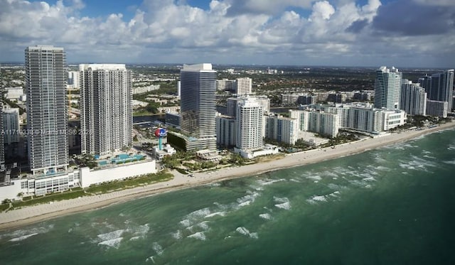 bird's eye view with a water view and a beach view