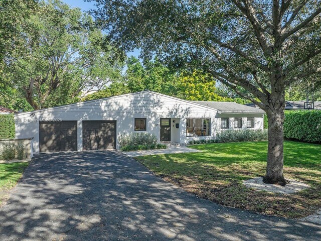 view of front of property with a front lawn and a garage