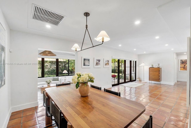 tiled dining room featuring a healthy amount of sunlight