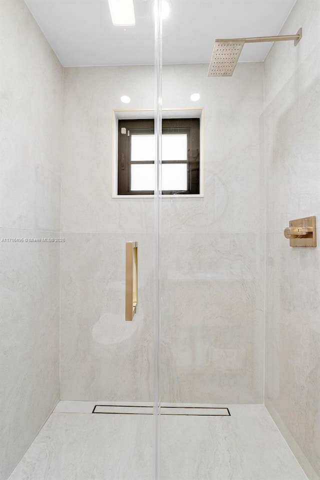 bathroom with a tile shower