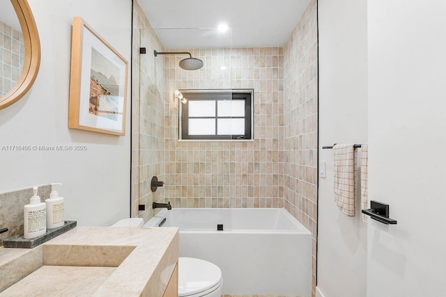 full bathroom with vanity, toilet, and tiled shower / bath combo