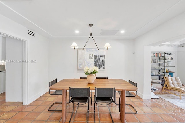 dining area featuring tile patterned floors and a chandelier