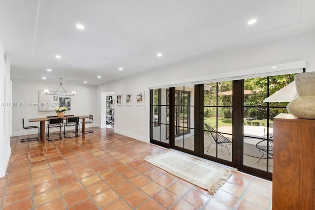 doorway featuring light tile patterned flooring and an inviting chandelier