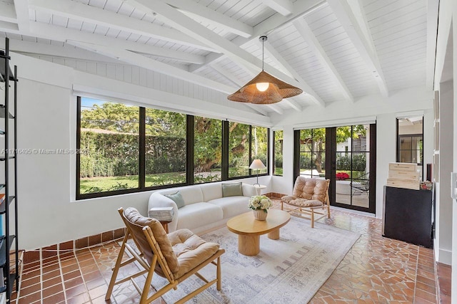 sunroom / solarium with french doors, plenty of natural light, and vaulted ceiling with beams