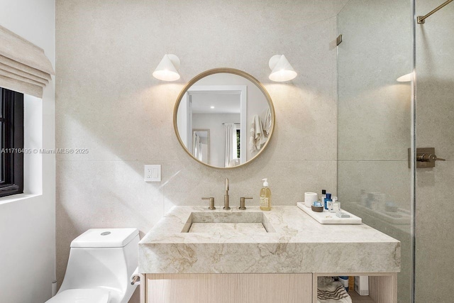 bathroom featuring vanity, tile walls, and toilet