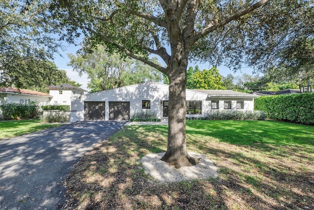 view of front of home featuring a garage and a front lawn