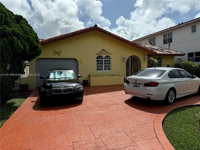 mediterranean / spanish-style home featuring a garage