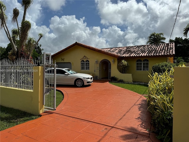 mediterranean / spanish home featuring a garage