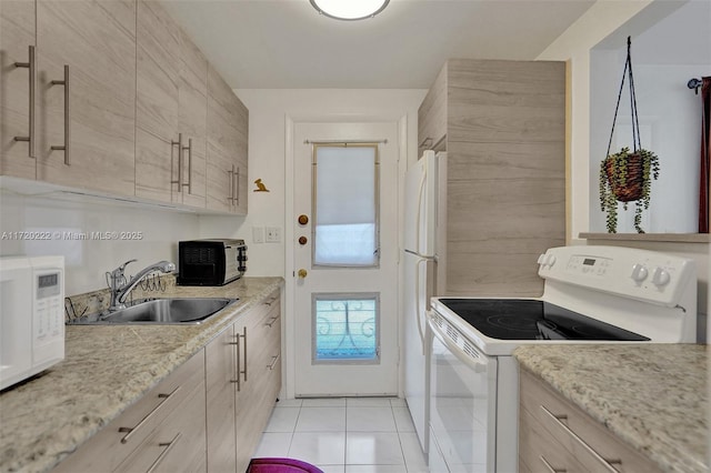 kitchen featuring sink, light stone counters, white appliances, light brown cabinetry, and light tile patterned flooring