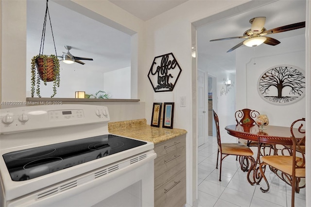 kitchen with light tile patterned floors and white electric range oven