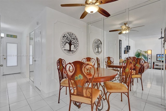 tiled dining space featuring ceiling fan