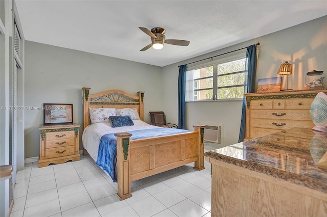 tiled bedroom featuring a wall unit AC and ceiling fan