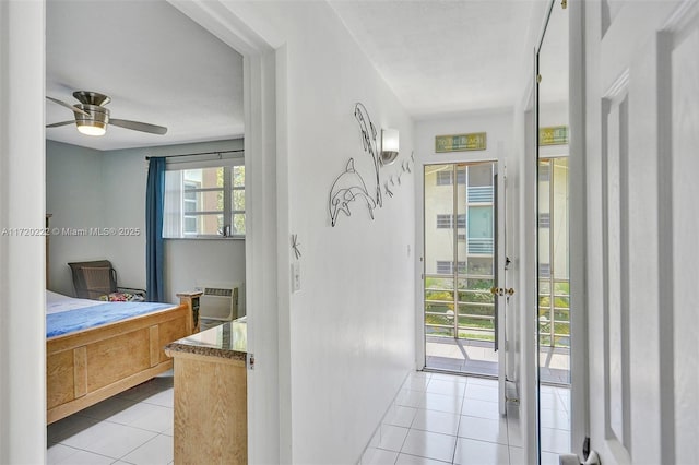 interior space with light tile patterned floors and a wall unit AC