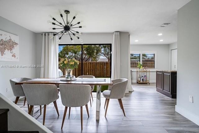 dining room featuring an inviting chandelier and light wood-type flooring