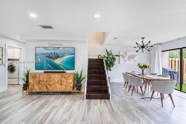 interior space featuring light hardwood / wood-style floors and washer / dryer