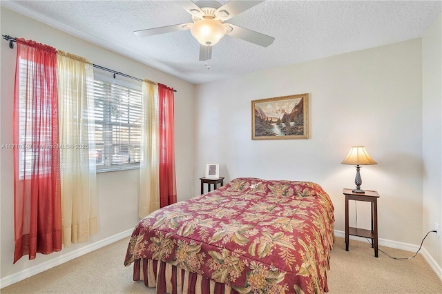 carpeted bedroom with ceiling fan and a textured ceiling