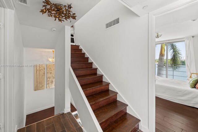 bedroom featuring a notable chandelier and dark hardwood / wood-style floors