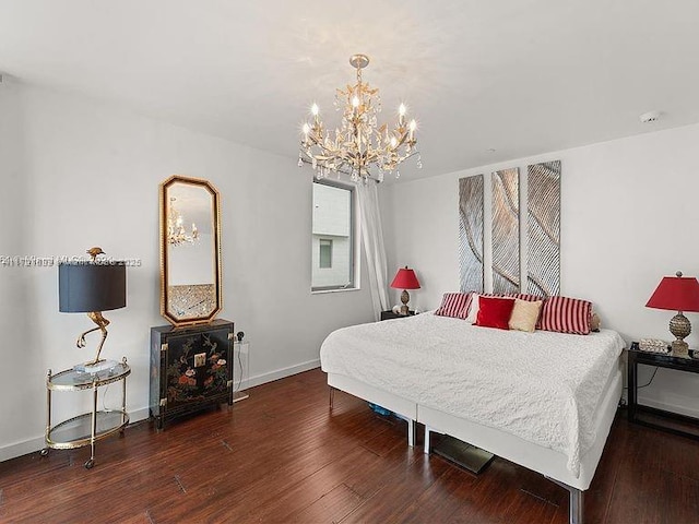 bedroom featuring dark wood-type flooring and a notable chandelier