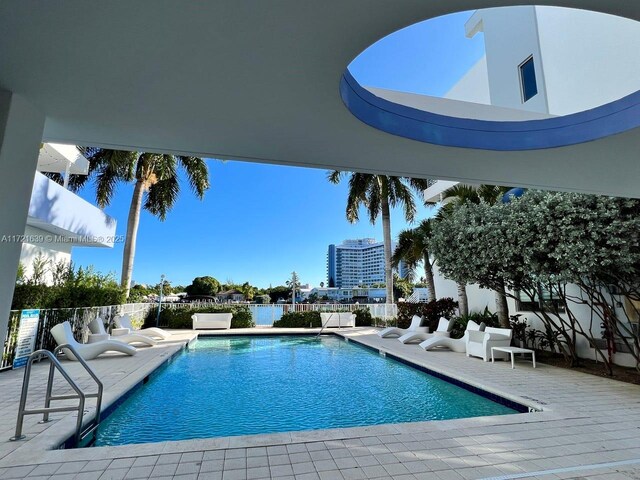 view of patio with a balcony and a water view