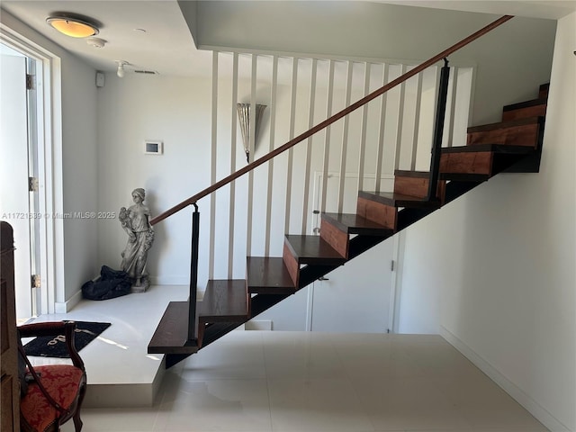 stairs featuring tile patterned floors