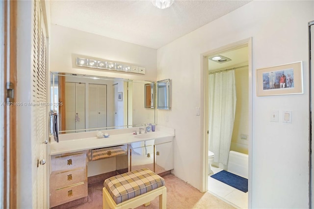 full bathroom featuring a textured ceiling, toilet, vanity, and shower / bath combination with curtain