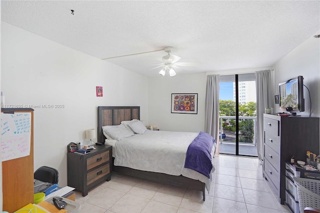 bedroom with light tile patterned floors, ceiling fan, access to exterior, and a textured ceiling