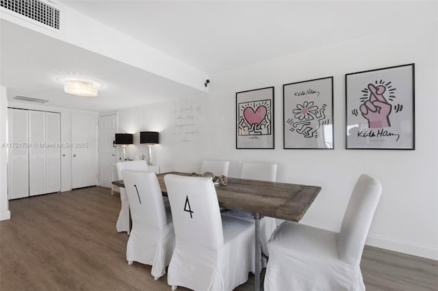 dining space featuring dark hardwood / wood-style flooring