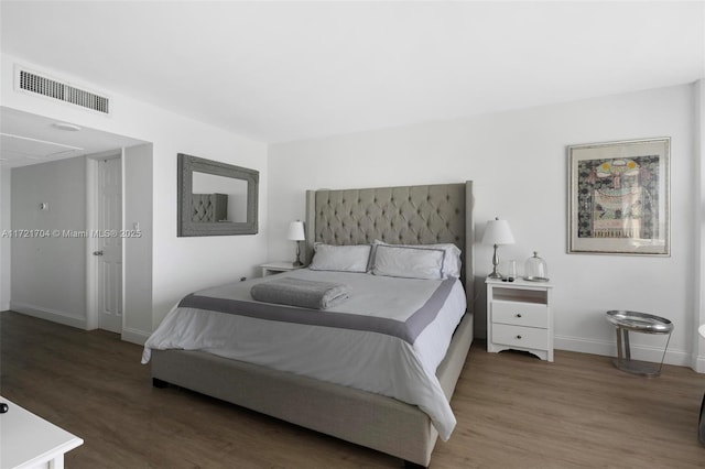 bedroom with dark wood-type flooring