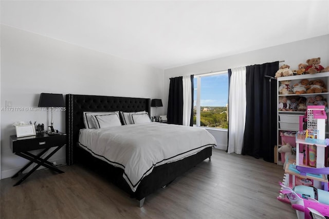 bedroom with hardwood / wood-style flooring