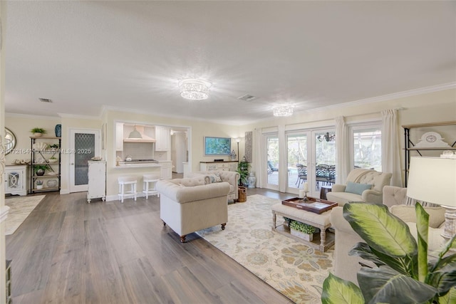 living room featuring ornamental molding, french doors, and dark hardwood / wood-style floors