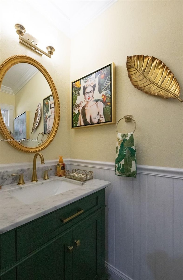 bathroom with crown molding and vanity