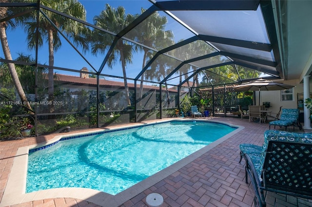 view of swimming pool with a patio and glass enclosure