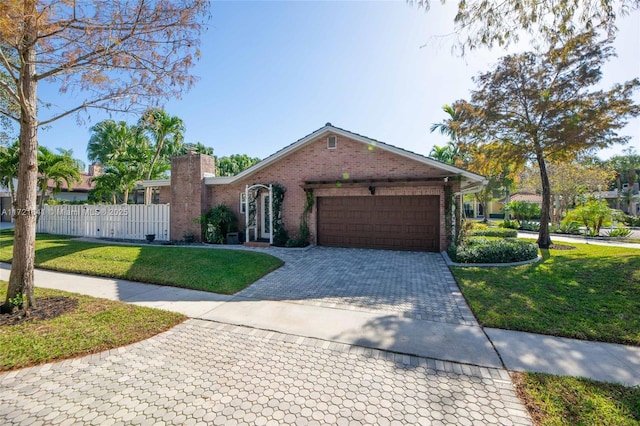 single story home featuring a front yard and a garage