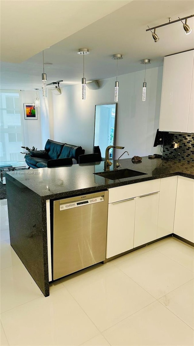 kitchen featuring pendant lighting, dishwasher, dark stone countertops, light tile patterned floors, and white cabinetry