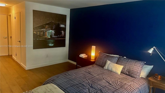 bedroom with hardwood / wood-style floors